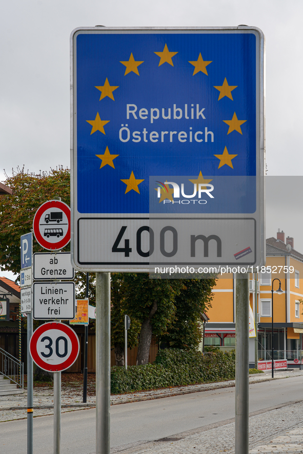 A blue border sign in Simbach, Germany, marks the boundary of the Schengen area between Germany and Austria, emphasizing the European Union’...