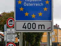 A blue border sign in Simbach, Germany, marks the boundary of the Schengen area between Germany and Austria, emphasizing the European Union’...