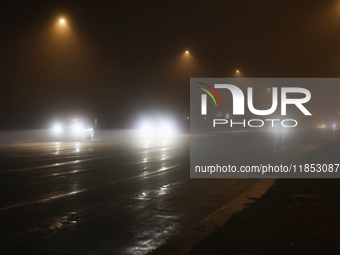 Drivers navigate the road as fog causing near-zero visibility blankets Toronto, Ontario, Canada, on December 9, 2024. (