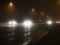 Drivers navigate the road as fog causing near-zero visibility blankets Toronto, Ontario, Canada, on December 9, 2024. (