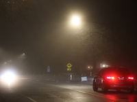 Drivers navigate the road as fog causing near-zero visibility blankets Toronto, Ontario, Canada, on December 9, 2024. (