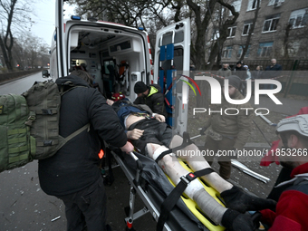 Paramedics place an injured person into an ambulance during a response effort to a Russian missile strike in Zaporizhzhia, Ukraine, on Decem...