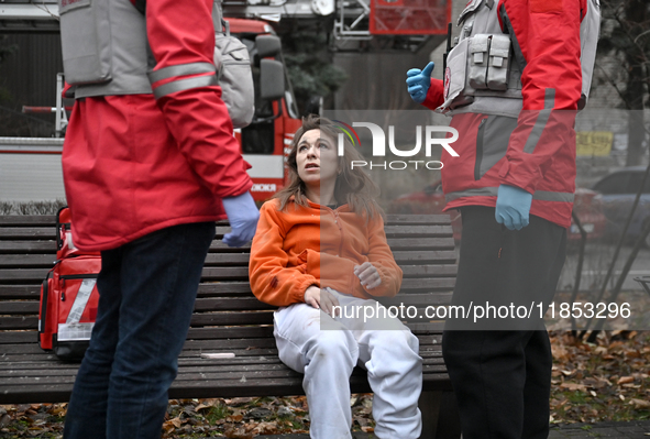 In Zaporizhzhia, Ukraine, on December 10, 2024, Rapid Response Team members talk to a woman injured by a Russian missile strike. Three peopl...