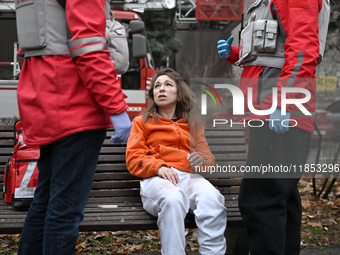 In Zaporizhzhia, Ukraine, on December 10, 2024, Rapid Response Team members talk to a woman injured by a Russian missile strike. Three peopl...