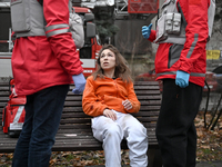 In Zaporizhzhia, Ukraine, on December 10, 2024, Rapid Response Team members talk to a woman injured by a Russian missile strike. Three peopl...