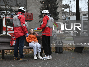 In Zaporizhzhia, Ukraine, on December 10, 2024, Rapid Response Team members talk to a woman injured by a Russian missile strike. Three peopl...