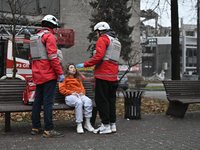 In Zaporizhzhia, Ukraine, on December 10, 2024, Rapid Response Team members talk to a woman injured by a Russian missile strike. Three peopl...