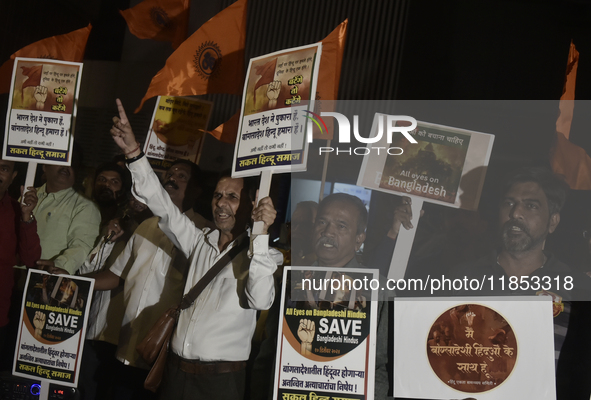 Indian Hindus hold placards and shout slogans during a protest seeking justice for minority Hindus in Bangladesh in Mumbai, India, on Decemb...