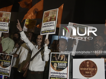 Indian Hindus hold placards and shout slogans during a protest seeking justice for minority Hindus in Bangladesh in Mumbai, India, on Decemb...