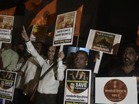 Indian Hindus hold placards and shout slogans during a protest seeking justice for minority Hindus in Bangladesh in Mumbai, India, on Decemb...