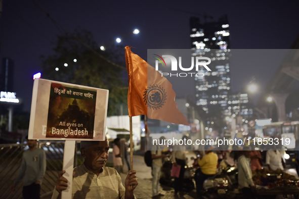 Indian Hindus hold placards and shout slogans during a protest seeking justice for minority Hindus in Bangladesh in Mumbai, India, on Decemb...