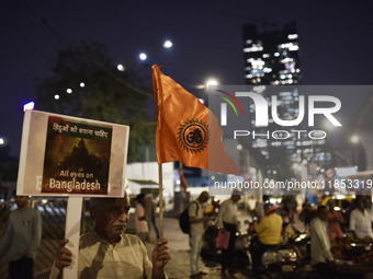 Indian Hindus hold placards and shout slogans during a protest seeking justice for minority Hindus in Bangladesh in Mumbai, India, on Decemb...