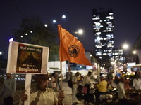 Indian Hindus hold placards and shout slogans during a protest seeking justice for minority Hindus in Bangladesh in Mumbai, India, on Decemb...