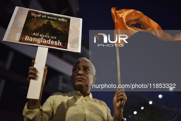 Indian Hindus hold placards and shout slogans during a protest seeking justice for minority Hindus in Bangladesh in Mumbai, India, on Decemb...