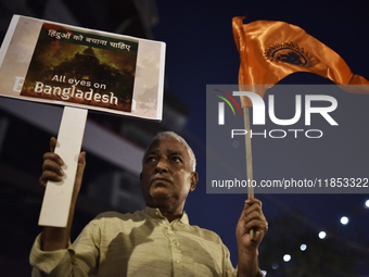 Indian Hindus hold placards and shout slogans during a protest seeking justice for minority Hindus in Bangladesh in Mumbai, India, on Decemb...