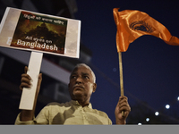 Indian Hindus hold placards and shout slogans during a protest seeking justice for minority Hindus in Bangladesh in Mumbai, India, on Decemb...