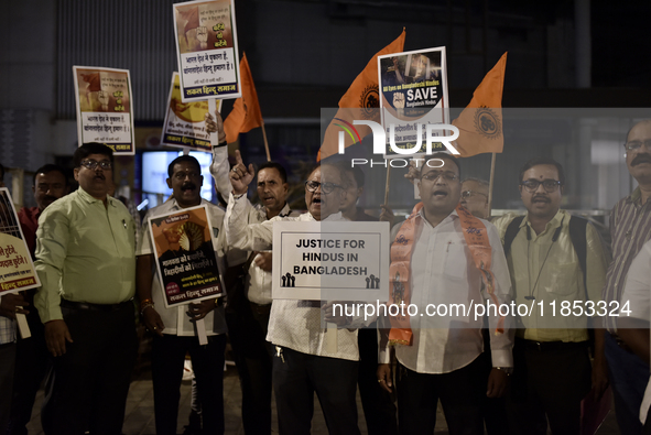 Indian Hindus hold placards and shout slogans during a protest seeking justice for minority Hindus in Bangladesh in Mumbai, India, on Decemb...