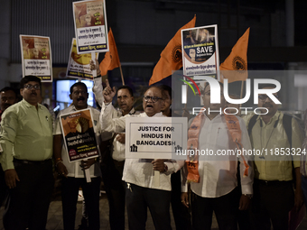 Indian Hindus hold placards and shout slogans during a protest seeking justice for minority Hindus in Bangladesh in Mumbai, India, on Decemb...