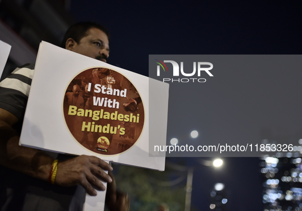 Indian Hindus hold placards and shout slogans during a protest seeking justice for minority Hindus in Bangladesh in Mumbai, India, on Decemb...