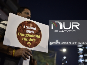 Indian Hindus hold placards and shout slogans during a protest seeking justice for minority Hindus in Bangladesh in Mumbai, India, on Decemb...