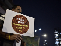 Indian Hindus hold placards and shout slogans during a protest seeking justice for minority Hindus in Bangladesh in Mumbai, India, on Decemb...