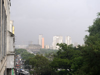 People walk with their umbrellas on a cloudy and rainy day in the center of Sao Paulo, Brazil, on December 10, 2024. (