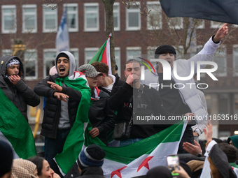 More than a hundred people celebrate post Al Assad in front of Duisburg Central Station in Duisburg, Germany, on December 10, 2024. (