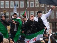 More than a hundred people celebrate post Al Assad in front of Duisburg Central Station in Duisburg, Germany, on December 10, 2024. (