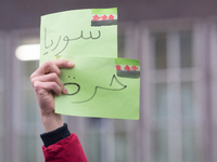 The sign of ''freedom Syria'' is seen as more than a hundred people celebrate post Al Assad in front of Duisburg Central Station in Duisburg...