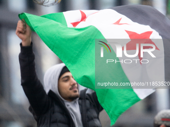 More than a hundred people celebrate post Al Assad in front of Duisburg Central Station in Duisburg, Germany, on December 10, 2024. (