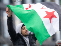 More than a hundred people celebrate post Al Assad in front of Duisburg Central Station in Duisburg, Germany, on December 10, 2024. (