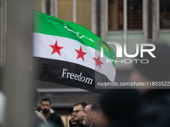 More than a hundred people celebrate post Al Assad in front of Duisburg Central Station in Duisburg, Germany, on December 10, 2024. (