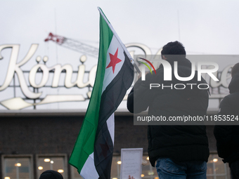 More than a hundred people celebrate post Al Assad in front of Duisburg Central Station in Duisburg, Germany, on December 10, 2024. (