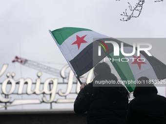 More than a hundred people celebrate post Al Assad in front of Duisburg Central Station in Duisburg, Germany, on December 10, 2024. (