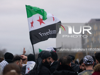 More than a hundred people celebrate post Al Assad in front of Duisburg Central Station in Duisburg, Germany, on December 10, 2024. (