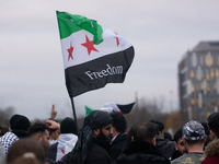 More than a hundred people celebrate post Al Assad in front of Duisburg Central Station in Duisburg, Germany, on December 10, 2024. (