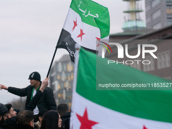 More than a hundred people celebrate post Al Assad in front of Duisburg Central Station in Duisburg, Germany, on December 10, 2024. (