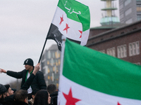 More than a hundred people celebrate post Al Assad in front of Duisburg Central Station in Duisburg, Germany, on December 10, 2024. (