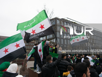 More than a hundred people celebrate post Al Assad in front of Duisburg Central Station in Duisburg, Germany, on December 10, 2024. (