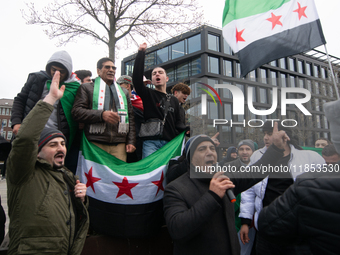 More than a hundred people celebrate post Al Assad in front of Duisburg Central Station in Duisburg, Germany, on December 10, 2024. (