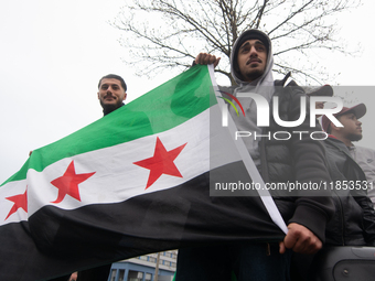 More than a hundred people celebrate post Al Assad in front of Duisburg Central Station in Duisburg, Germany, on December 10, 2024. (