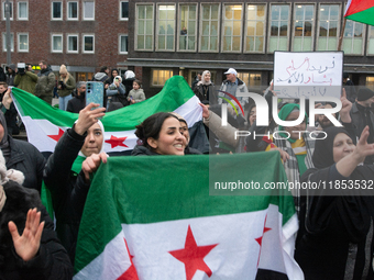 More than a hundred people celebrate post Al Assad in front of Duisburg Central Station in Duisburg, Germany, on December 10, 2024. (