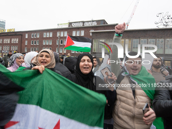 More than a hundred people celebrate post Al Assad in front of Duisburg Central Station in Duisburg, Germany, on December 10, 2024. (