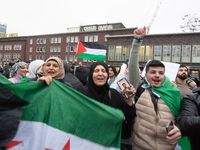 More than a hundred people celebrate post Al Assad in front of Duisburg Central Station in Duisburg, Germany, on December 10, 2024. (