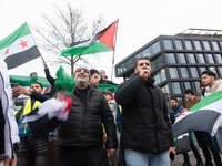 More than a hundred people celebrate post Al Assad in front of Duisburg Central Station in Duisburg, Germany, on December 10, 2024. (