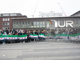 More than a hundred people celebrate post Al Assad in front of Duisburg Central Station in Duisburg, Germany, on December 10, 2024. (