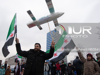 More than a hundred people celebrate post Al Assad in front of Duisburg Central Station in Duisburg, Germany, on December 10, 2024. (