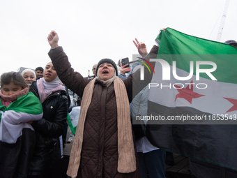 More than a hundred people celebrate post Al Assad in front of Duisburg Central Station in Duisburg, Germany, on December 10, 2024. (