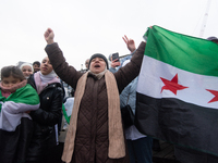 More than a hundred people celebrate post Al Assad in front of Duisburg Central Station in Duisburg, Germany, on December 10, 2024. (