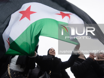 More than a hundred people celebrate post Al Assad in front of Duisburg Central Station in Duisburg, Germany, on December 10, 2024. (